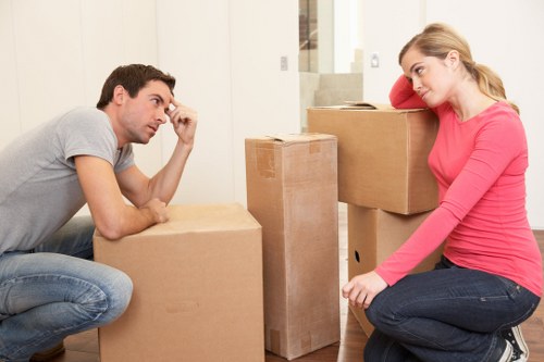 Professional movers handling office equipment with care
